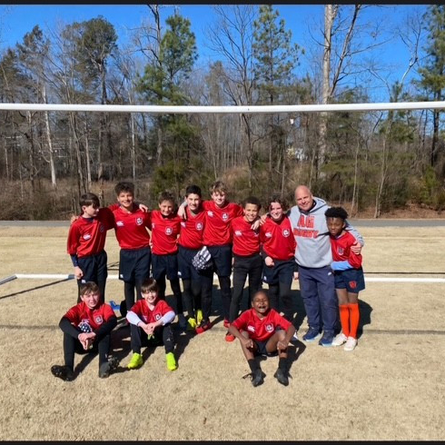 Dr. Cook with the youth rugby team in a group photo.