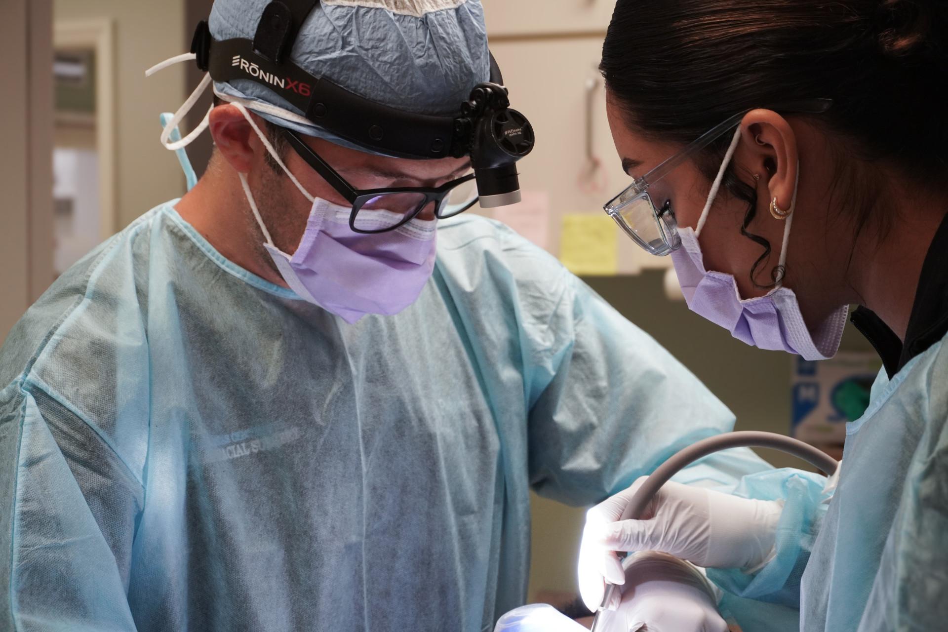 oral surgeon performing wisdom teeth extraction