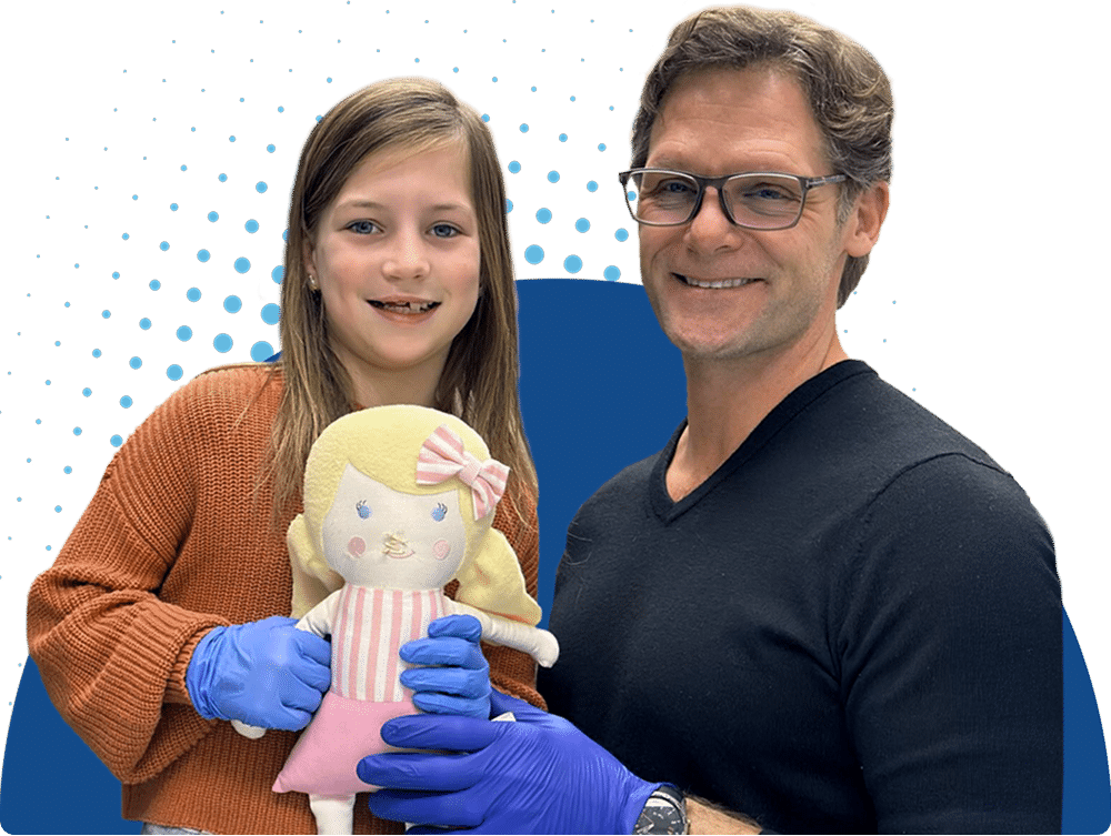 A smiling child and person with glasses hold a doll, wearing blue gloves, against a graphic background with blue dots.