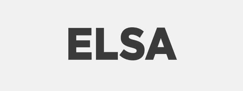 Aerial view of Paris, showing the Eiffel Tower. The cityscape includes buildings, roads, and trees under a clear blue sky. Bustling urban scenery.